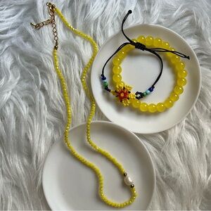 Yellow colored jewelry set with necklace and two bracelets